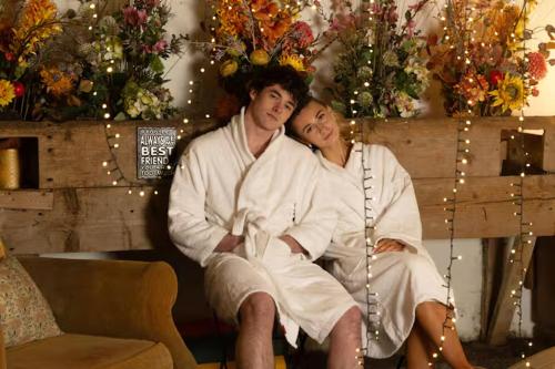a man and woman sitting on a bench with christmas lights at Fitz Of Inch in Stradbally