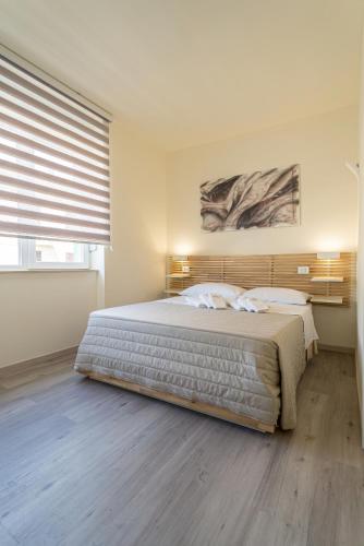 a bedroom with a large bed and a large window at Rooms & Breakfast Centrale in Fabriano