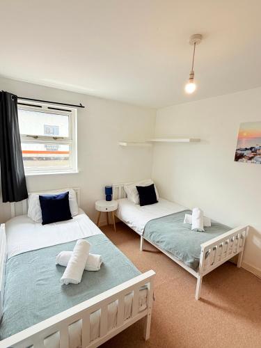 a room with two beds and a window at Penthouse with City Views in Bristol