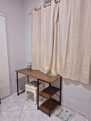 a table in a room with a curtain at Casa Studio 1 Quarto in São José dos Campos