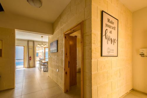 a hallway with a stone wall with a door at Nadurin Holiday Home in Nadur