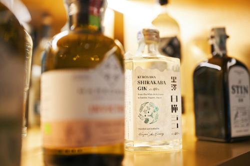 three bottles of alcohol sitting on a table at Albergo Pompei Valley - Boutique Hotel in Pompei