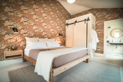 a bedroom with a bed and a stone wall at Mallard Inn in St. John's