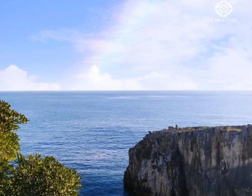 a view of the ocean with a large cliff at Opportunity Room Suite Cascais Guia in Cascais