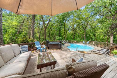 a patio with a couch and a table and a pool at Treehouse Oasis in New Buffalo