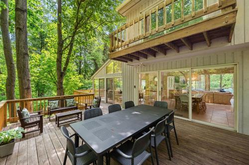 a patio with a table and chairs on a deck at Treehouse Oasis in New Buffalo