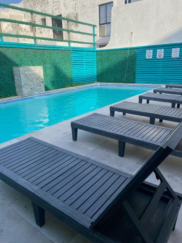 two picnic tables in front of a swimming pool at Loft Frente a la Playa!!!! in Boca del Río