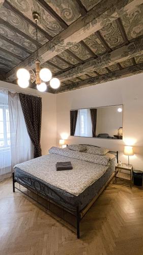 a bedroom with a bed and a ceiling with a mirror at At the Blue Lion & Parking Assistance in Prague