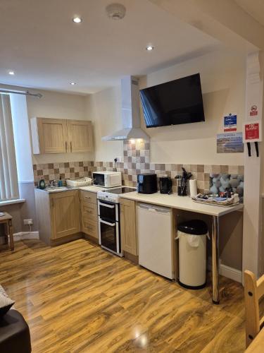 a kitchen with a sink and a stove top oven at Appletorre House Holiday Flats - Pet Friendly by arrangement and Private Parking in Torquay