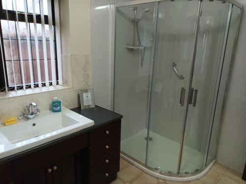 a bathroom with a shower and a sink at The Chantry, North Wing, Cottage in Hemsby