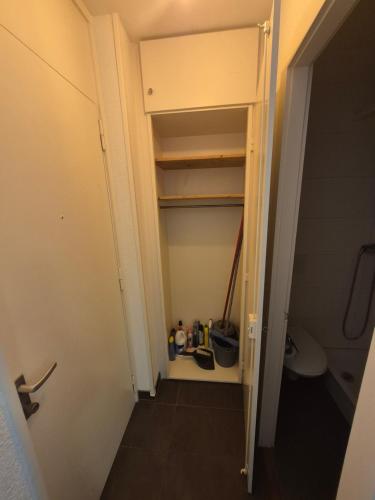 a small bathroom with a closet with a toilet at Studio proche gare et Lausanne in Renens