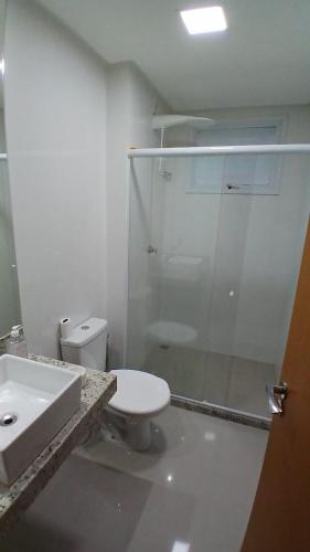 a bathroom with a shower and a toilet and a sink at Cozy Apartment in Domingos Martins