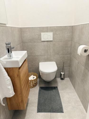 a bathroom with a toilet and a sink at Apart Pair im Dorf in Schwendau