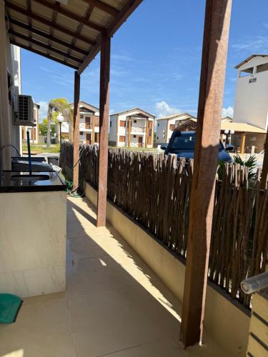 a wooden fence in front of a house at Paraíso dos Lençóis casa 08 Atins in Atins