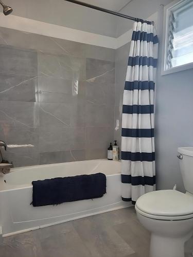 a bathroom with a tub and a toilet and a shower at Upcountry Maui Hideaway with Stunning Mountain Views in Makawao