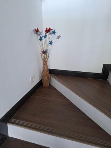 a vase with flowers sitting on a stair case at Aquahills in Kandy