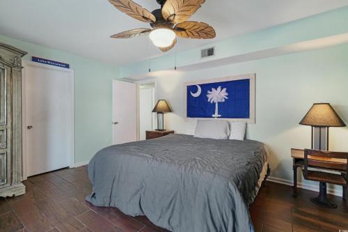 a bedroom with a bed and a ceiling fan at Mai Tu Suns - Renovated 3 Bedroom Beach Home! in Myrtle Beach