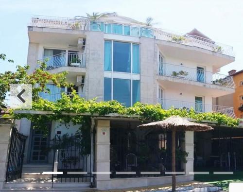 a building with an umbrella in front of it at Hotel NEMO in Kiten