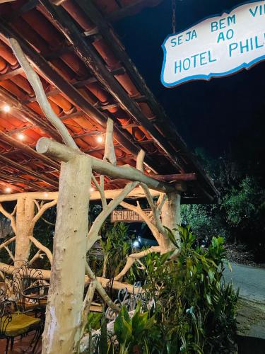 a sign for a hotel building with a tree at Hotel Philipp - Tradicional desde 1952 in Teresópolis