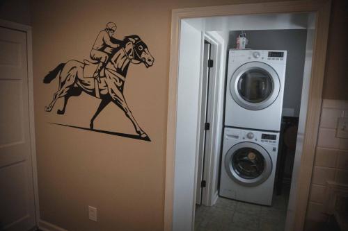 a stencil of a jockey riding a horse on a wall in a hallway at 1939 Four Bed Rustic Escape by Casino in Ranson