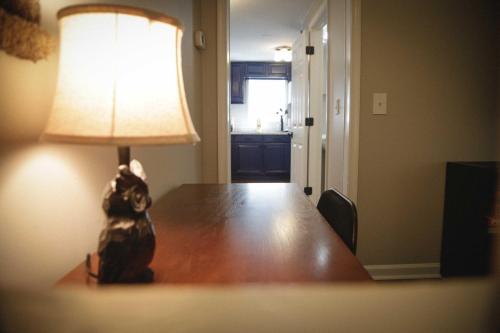 a cat sitting on a table next to a lamp at 1939 Four Bed Rustic Escape by Casino in Ranson
