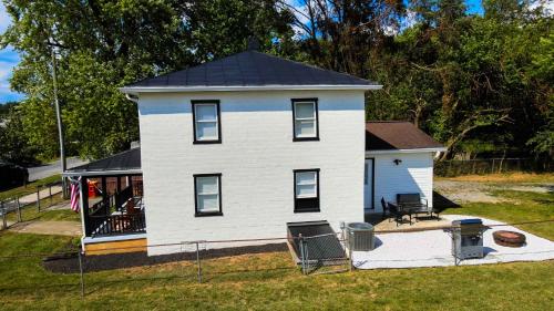 a small white house with a black roof at 1939 Four Bed Rustic Escape by Casino in Ranson