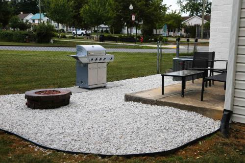 a fire pit and a table in a yard at 1939 Four Bed Rustic Escape by Casino in Ranson