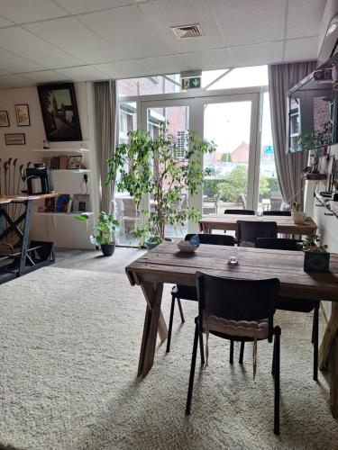 a large room with a wooden table and chairs at Thorn BenB in Thorn