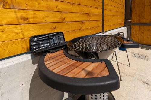 a barbecue grill with a bench and a table at Dimora 59 in Santa Maria Imbaro