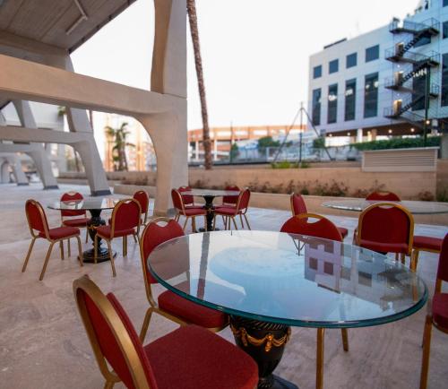 a glass table and chairs on a patio at Ekilibrio Hotel & Apart-Suites in Madrid