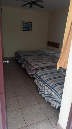 Ένα ή περισσότερα κρεβάτια σε δωμάτιο στο Hotel Perseo Inn
