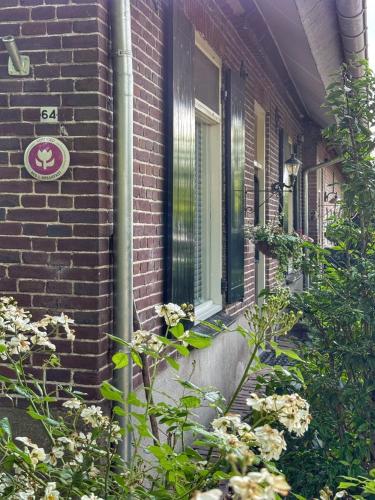 a brick house with a sign on the side of it at Nisterlo Guesthouse in Nistelrode