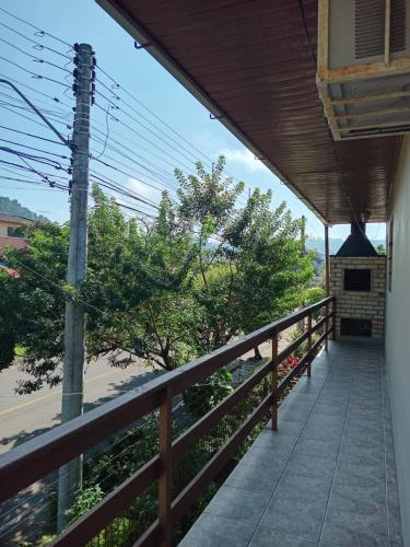 a balcony of a house with a view of a street at Hospedaria das Azaleias in Novo Hamburgo