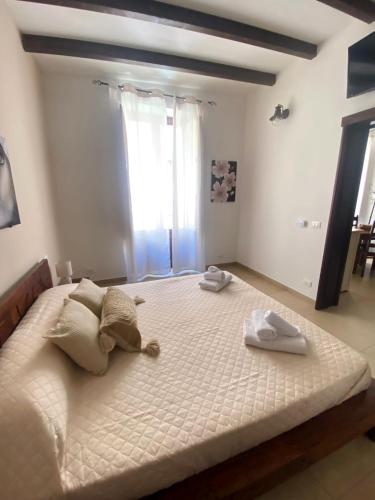 a bedroom with a large bed with two towels on it at Il Moro di Ossuna in Trapani