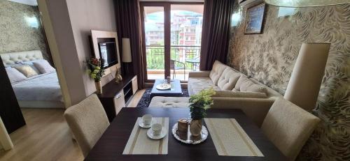 a living room with a couch and a table at Patrick's apartments - Harmony Palace in Sunny Beach