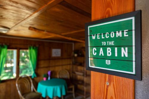 a welcome to the cabin sign on a wall at FOREST, lake, FIREFLIES, campfire - WHAT ELSE in Jindrichuv Hradec