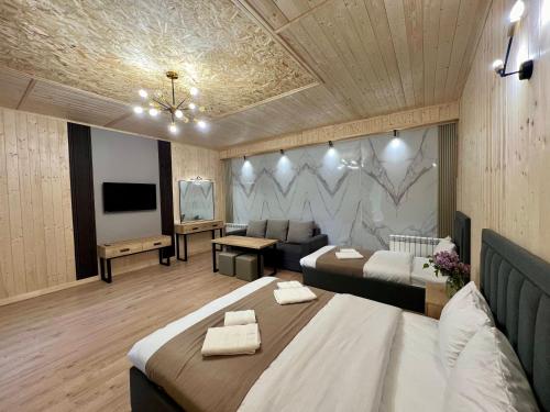 a large room with two beds and a television at Milenium magic villas on Sevan beach in Sevan
