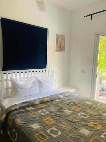 a bedroom with a bed with a large window at El patio de Lucia, center 4 people Las Terrenas in Las Terrenas