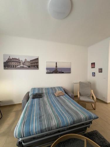 a bed in a room with paintings on the wall at Casa Alimonda in Genoa