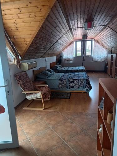 a bedroom with a bed and a couch in a room at Casa OZZY&PATTY in 2 Mai