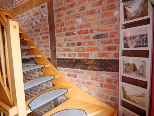 a room with a brick wall and shelves with surfboards at Ferienwohnung Backbord im Zentrum von Röbel in Röbel