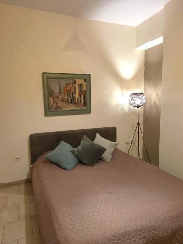 a bedroom with a bed with two pillows on it at Leonidas Private Apartment in Sparta in Sparti