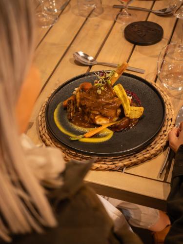 a plate of food with french fries on a table at Ukanyi Luxury Villa in Hoedspruit