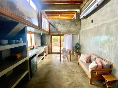 a living room with a couch and a table at Hermanos Perdidos Surf in Las Tunas