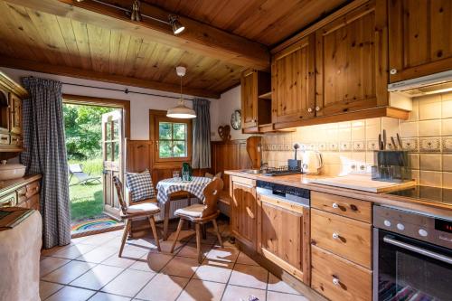 a kitchen with wooden cabinets and a table and chairs at KaiserGattern in Going