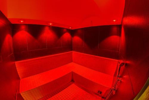 a red room with a shower with red lights at Victoria Hotel in Pescara