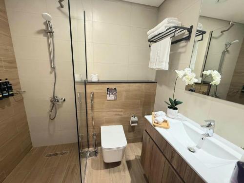 a bathroom with a toilet and a sink and a shower at 1 Bedroom in Maryah Island by Central Stay 1 min to Cleveland, Galleria Mall and ADGM in Abu Dhabi