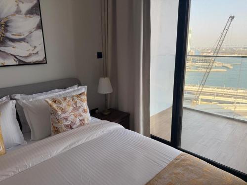 a bedroom with a bed with a view of an airport at 1 Bedroom in Maryah Island by Central Stay 1 min to Cleveland, Galleria Mall and ADGM in Abu Dhabi