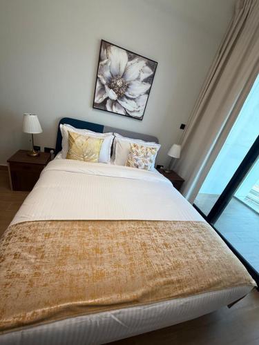 a bedroom with a large bed and a window at 1 Bedroom in Maryah Island by Central Stay 1 min to Cleveland, Galleria Mall and ADGM in Abu Dhabi