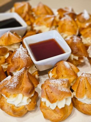 a pile of pastries with a bowl of dipping sauce at ZLATIBOR HIGHLAND in Zlatibor